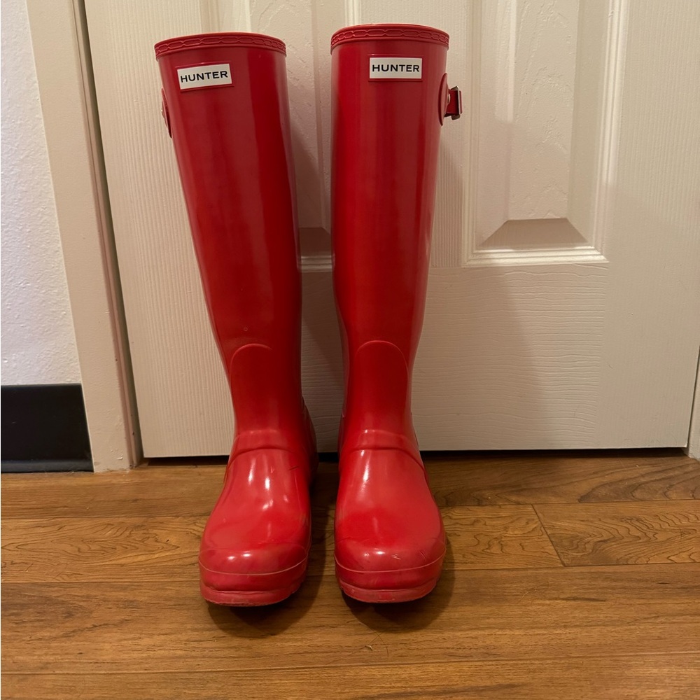 Beautiful cherry red hunter boots. Barely used. One of the straps is loose.